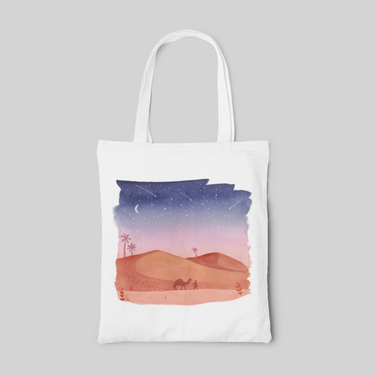 White tote bag with blue to pink gradient sky in the desert