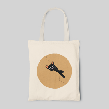minimalist designed tote bag with a cute cartoon black cat inside a light brown circle, front side