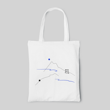 White tote bag with simple blue line drawing of mountains and clouds