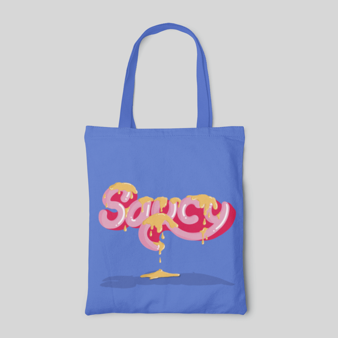 Bright blue designed tote bag with pink 'saucy' lettering and dripping of yellow sauces, front side