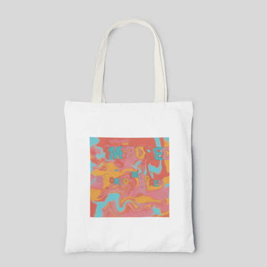 White abstract tote bag with yellow pink blue and coral tie dye and wobbly lettering, front side