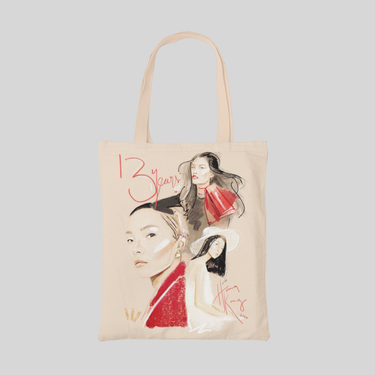 Beige tote bag with three girl faces wearing red 