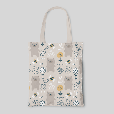Beige designed tote bag with cute cartoon bear, bee and flower illustration pattern, front side