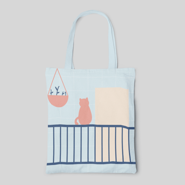 minimalist designed light blue tote bag with a cat on ledge themed, front side