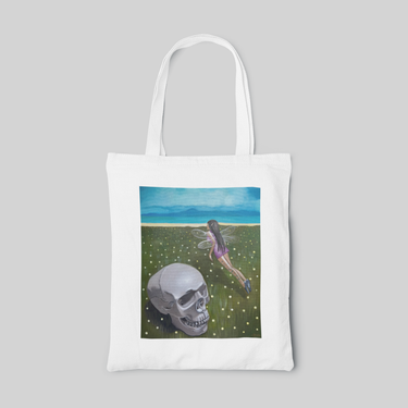 lowbrow designed tote bag with a fairy and skeleton head in the land full of grass, front side