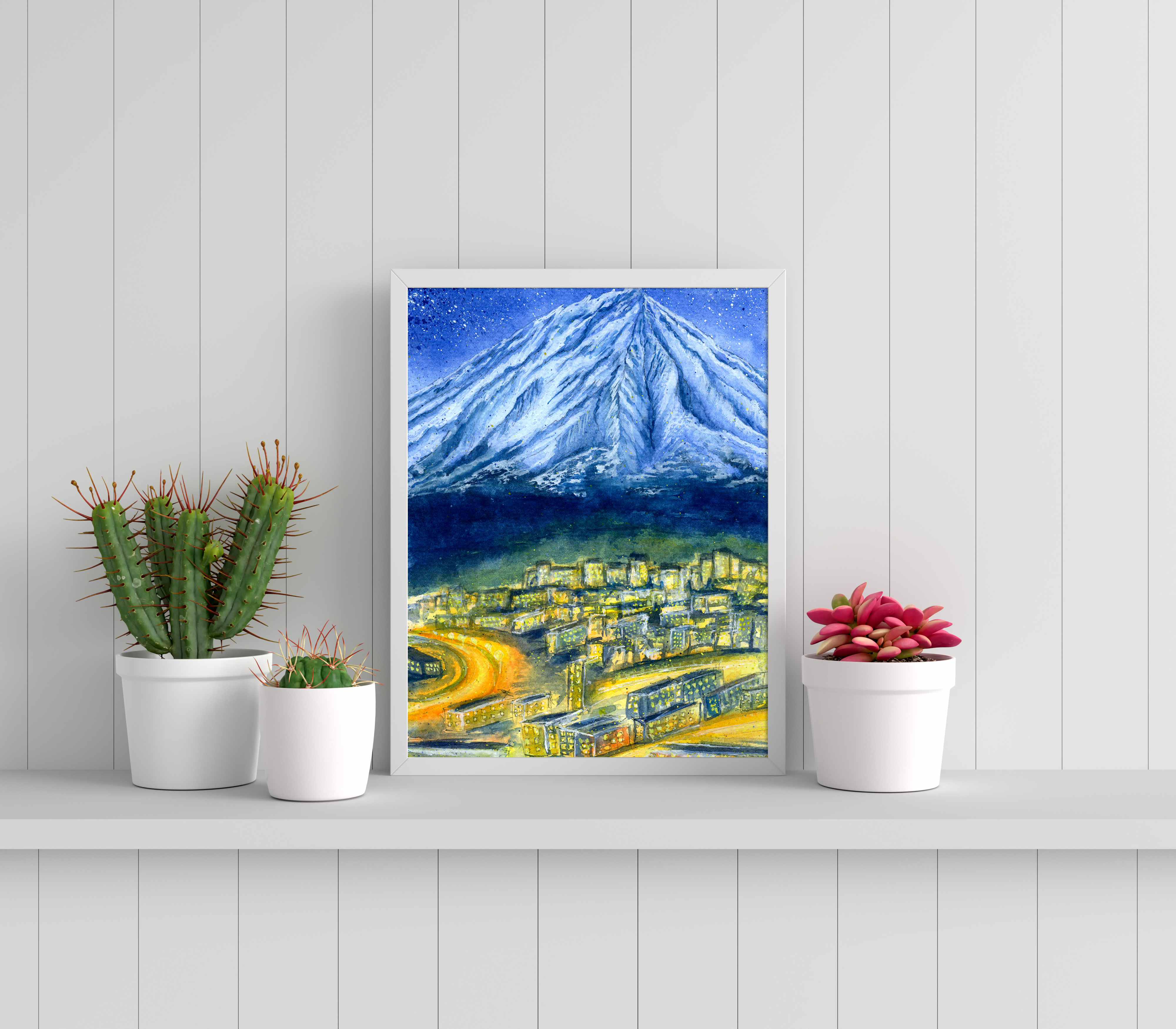 Icy light blue mountain above yellow lit village below