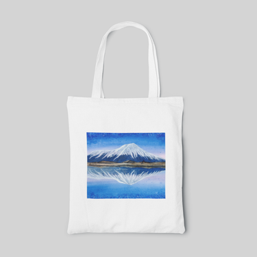 White nature designed tote bag with blue landscape of volcano above water, front side