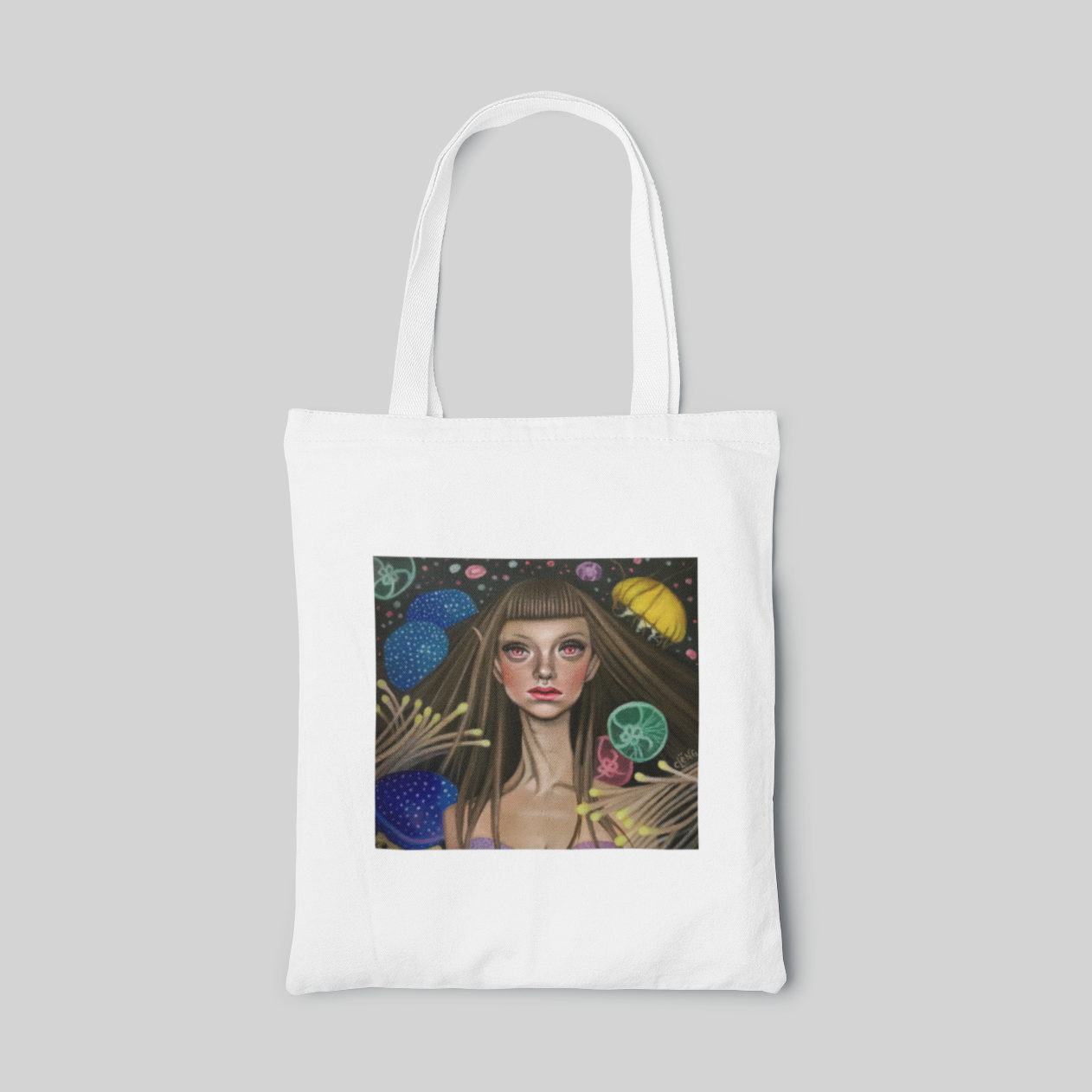 white lowbrow designed tote bag with a girl surrounded by many colourful jellyfishes in a dark background, front side