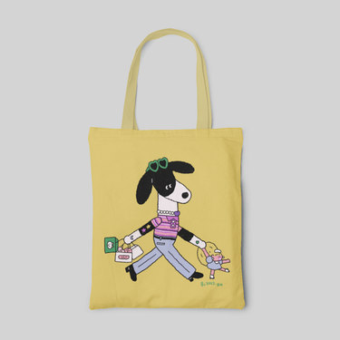 yellow lowbrow designed tote bag with a cartoon dog wearing fancy clothes and shopping with a little girl, front side