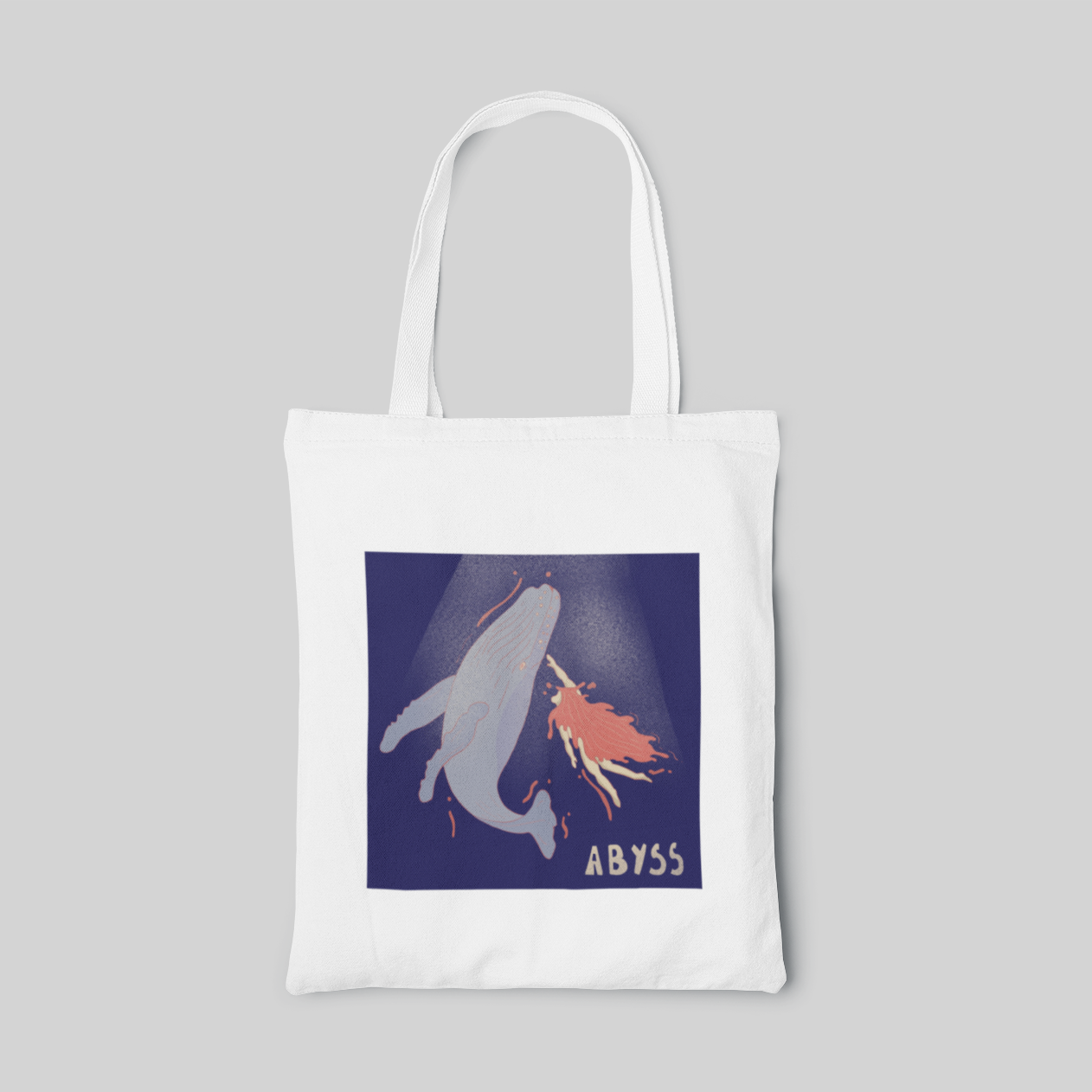 White lowbrow designed tote bag with a girl swimming towards the dying whale in dark blue sea, front side