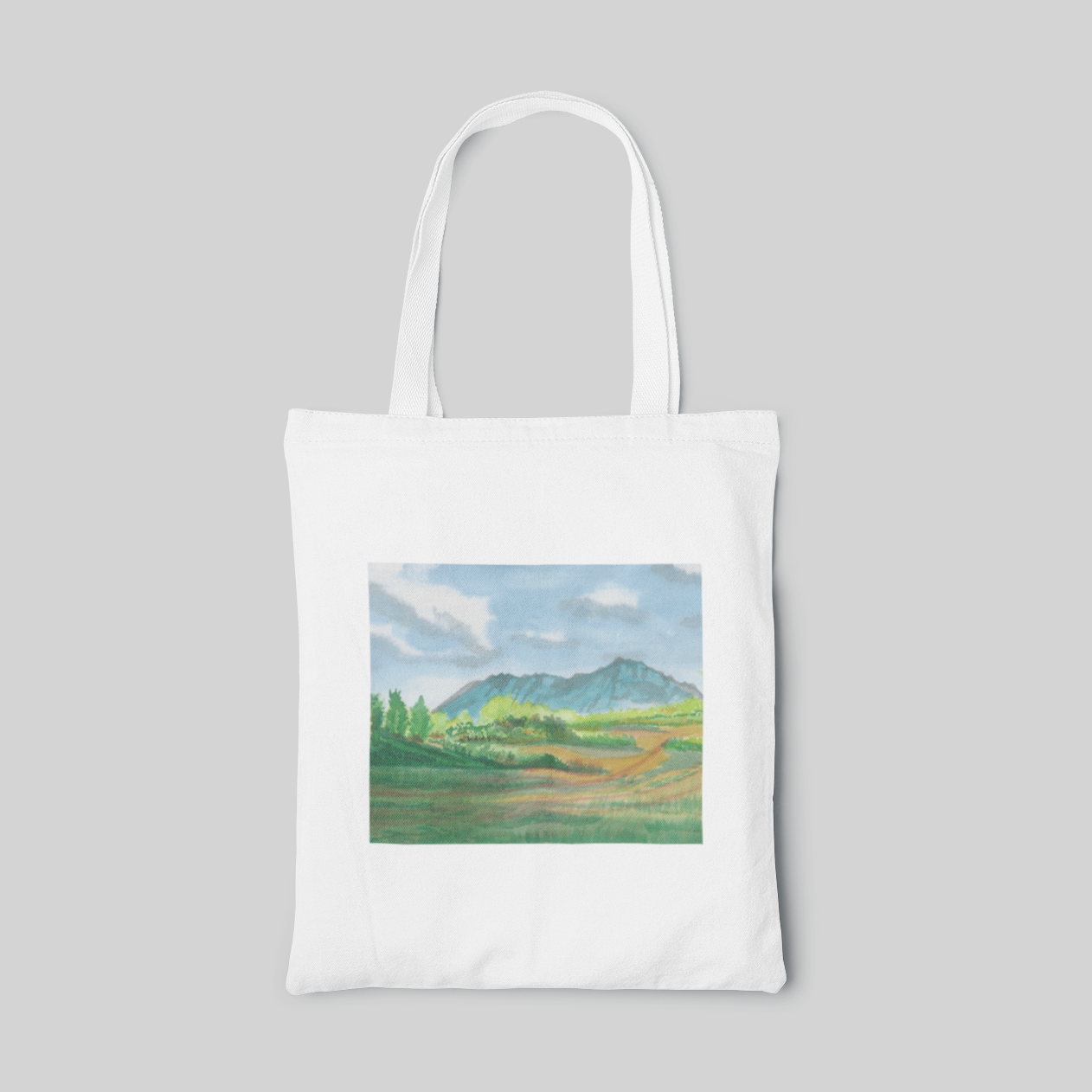 watercolour designed white tote bag with green and blue landscape, front side