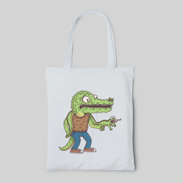 Light blue lowbrow designed tote bag with cartoon crocodile in brown shirt and jeans and holding a lizard's legs, front side