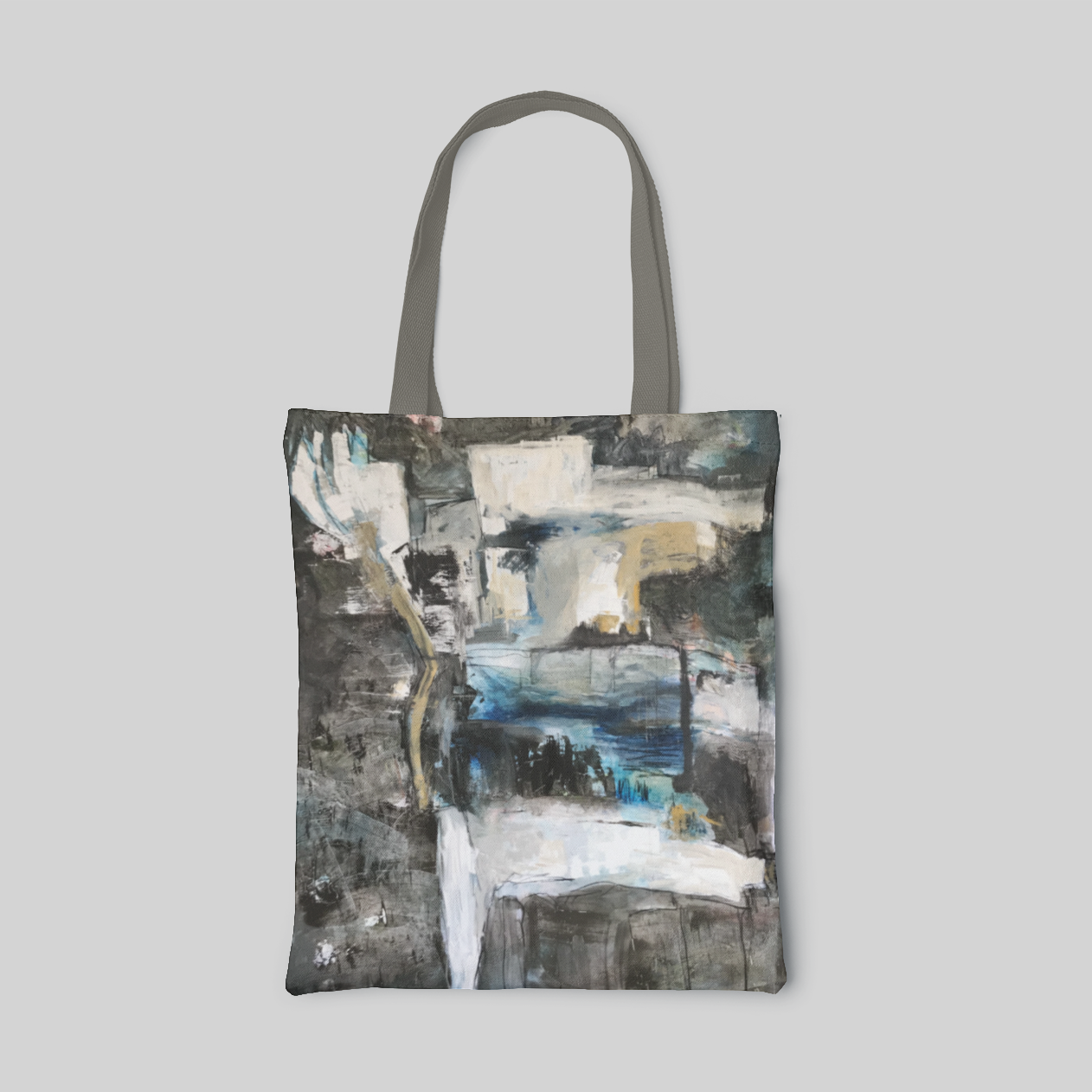 grey abstract designed tote bag with dark grey and white base and pale ochre and blue highlight, front side
