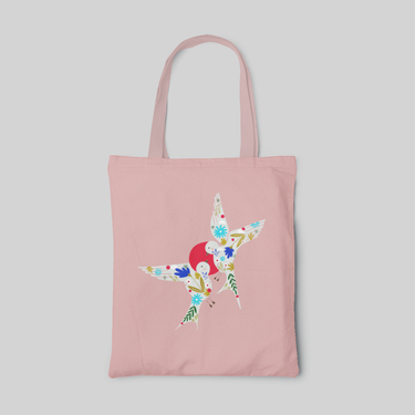 Pink minimalist designed tote bag with two white bird silhouettes with flower and leaves patterns, and a red dot between the birds, front side