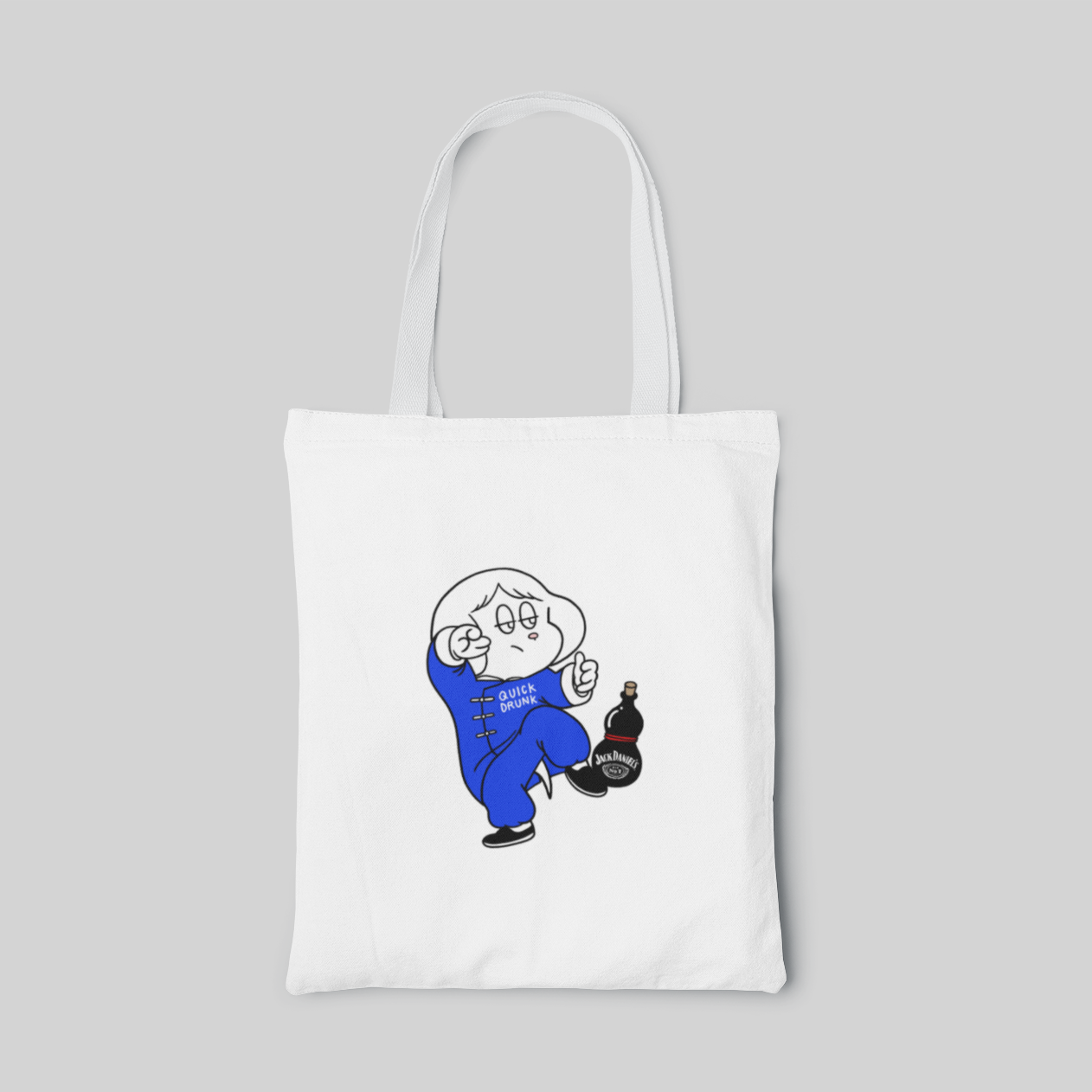 White lowbrow designed tote bag with girl wearing blue martial arts clothing and holding a bottle of whisky on her leg, front side